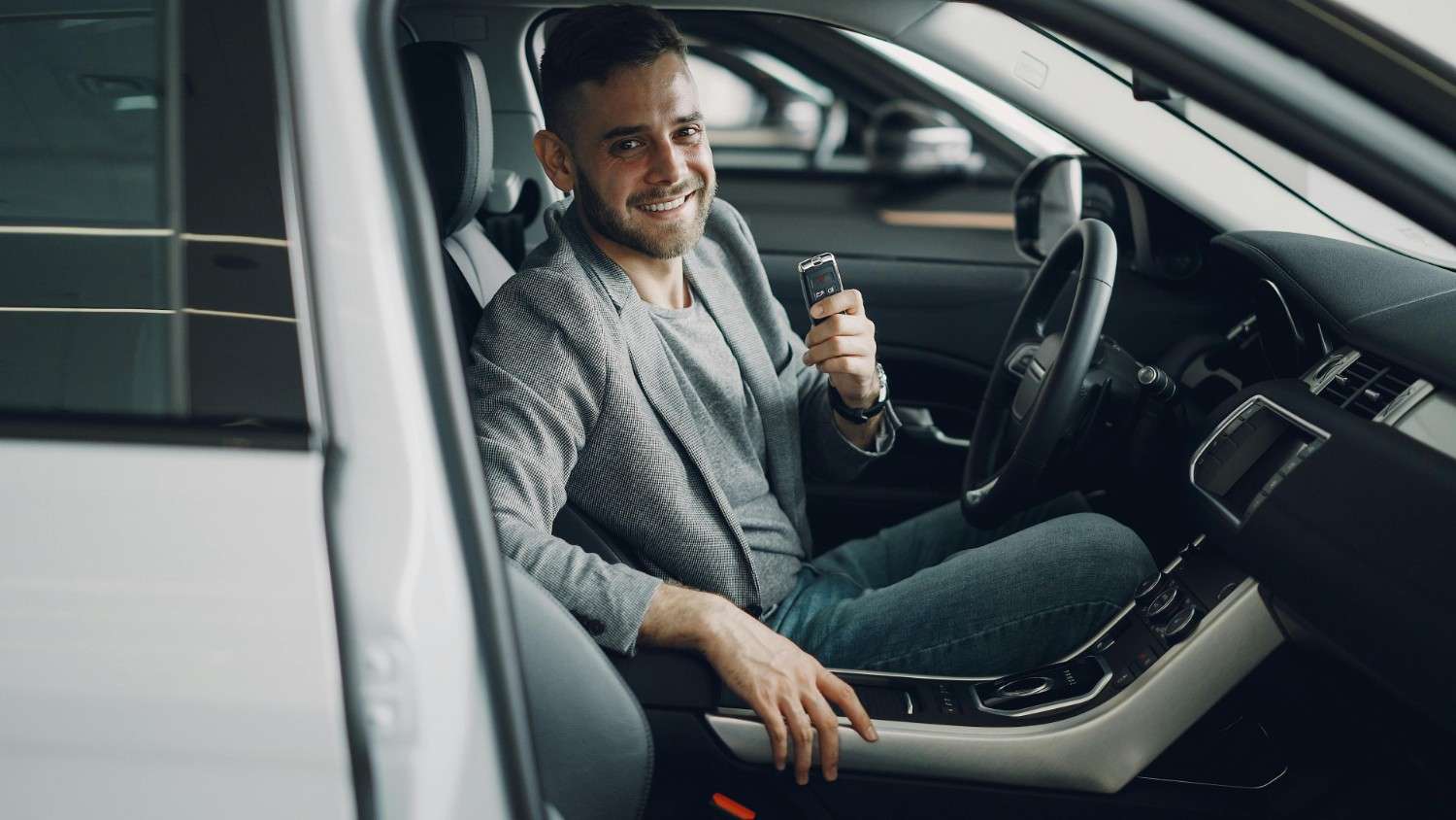High-quality image showing a happy driver holding car keys in a safe environment